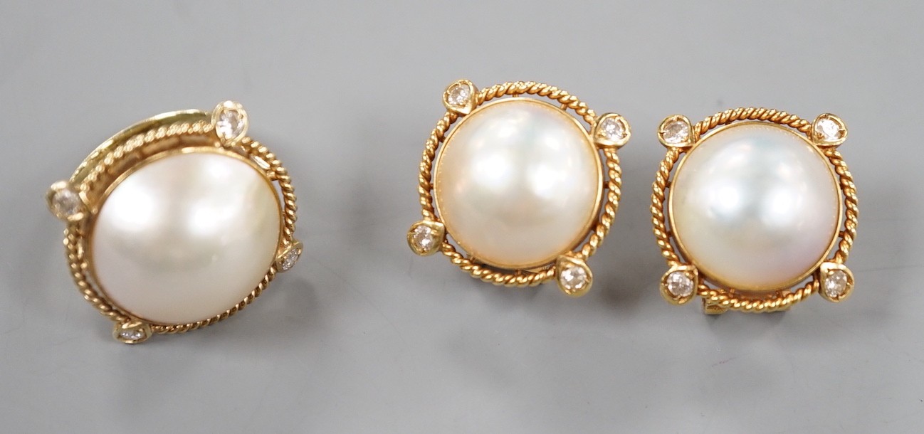 A yellow metal, mabe pearl and four stone diamond chip set dress ring, size H and a pair of similar earrings stamped 585 14k, gross weight 17.1 grams.